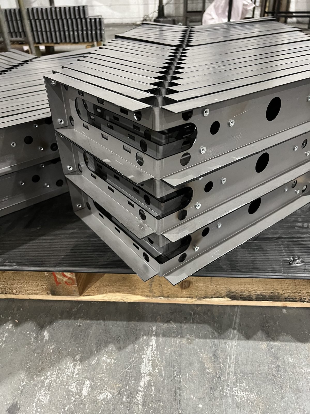 Stack of folded stainless steel bases with PEM fastener inserts